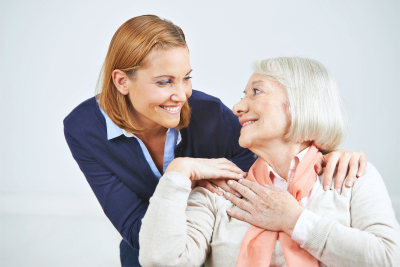 happy elderly woman smiling with a social worker